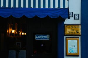 Cozy restaurant entrance with a striped awning in Antonina, Brazil.