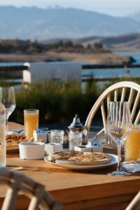 Enjoy a picturesque meal by the lake with delicious food and serene views in Morocco.